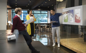 Epson CO-WX01 projector in a small business meeting displaying a presentation.