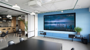 The Epson EB-L210SW projector used in a business meeting room setup.